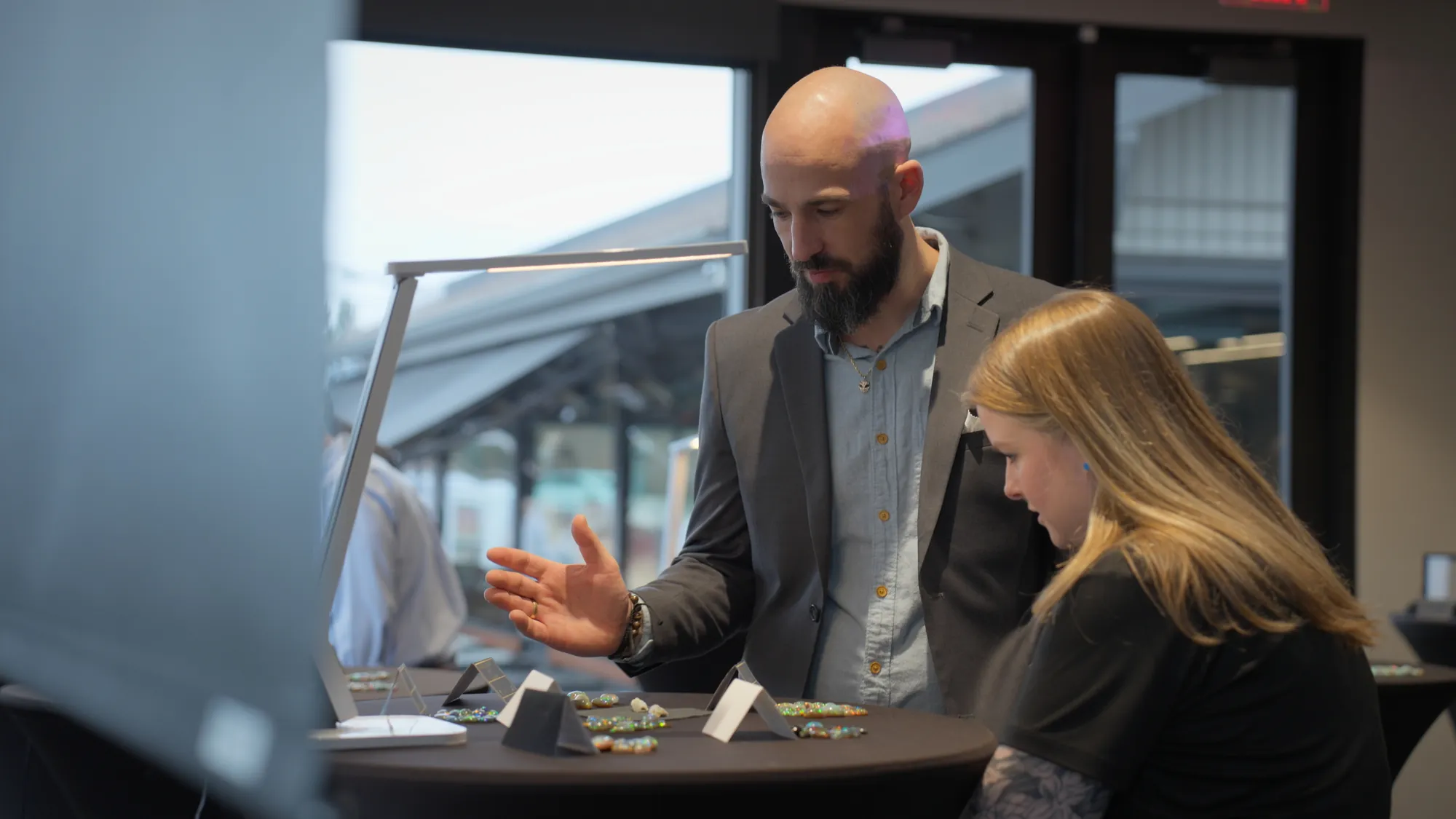 Walking a client through a selection of stones at an international gem show